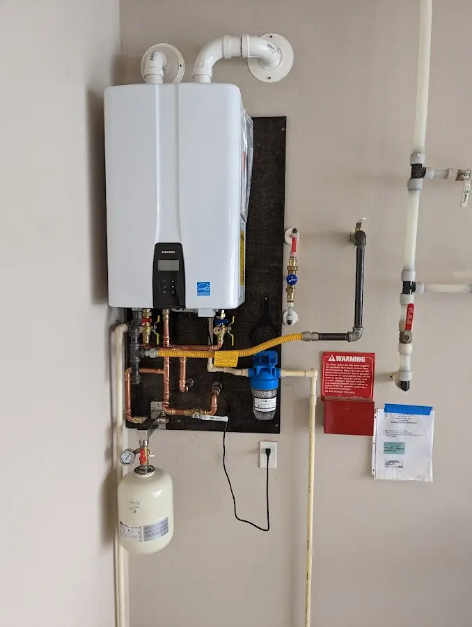 Professional plumber installing copper piping in a Woodlawn home